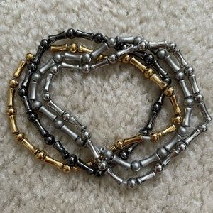 Set of 4 gold, black, silver and brushed silver Lia Sophia stretch bracelets